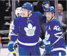  ?? FRANK GUNN
THE CANADIAN PRESS ?? Toronto Maple Leafs left wing James van Riemsdyk, left, celebrates a goal with teammate Tyler Bozak.