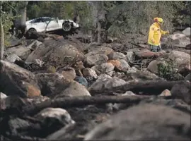  ?? Wally Skalij Los Angeles Times ?? OFFICIALS said they worried early morning phone alerts for potential mudslides wouldn’t be taken seriously. Above, a firefighte­r Wednesday searches for victims.