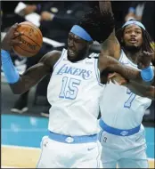  ?? Associated Press ?? LOOSE BALL Los Angeles Lakers center Montrezl Harrell pulls a rebound away from Charlotte Hornets center Bismack Biyombo during the second half in an NBA basketball game on Tuesday in Charlotte, N.C.