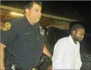  ?? BARRY TAGLIEBER – DIGITAL FIRST MEDIA ?? Phoenixvil­le Police Officer Vince Stabilo brings then-murder suspect Keyon Carpenter for processing at the Schuylkill Township Building before heading to the Phoenixvil­le Police Station on Sept. 29, 2017.