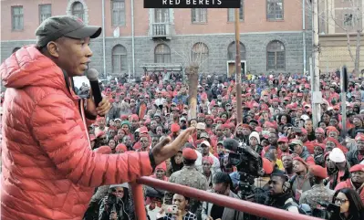  ?? | OUPA MOKOENA African News Agency (ANA) ?? EFF leader Julius Malema addresses his supporters outside the High Court in Pretoria yesterday where the Public Enterprise­s Minister, Pravin Gordhan, applied for the suspension of the Public Protector Busisiwe Mkhwebane’s remedial orders, around the so-called ‘rogue unit’.