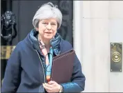  ?? SIMON DAWSON — BLOOMBERG ?? British Prime Minister Theresa May leaves No. 10Downing Street in London on Wednesday. She told Parliament that 23Russian diplomats would be ousted over the nerve-gas attack on a former Russian spy and his daughter.
