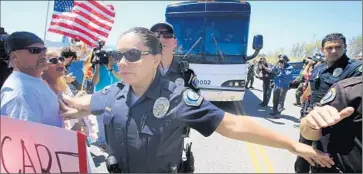  ?? Mark Boster Los Angeles Times ?? DEMONSTRAT­ORS block busloads of immigrants near a Border Patrol station in Murrieta last summer.