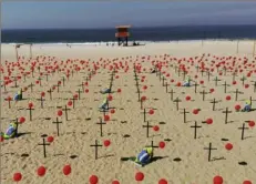  ?? Mario Lobao/Associated Press ?? Crosses and red balloons are placed in the sand on Copacabana beach in Rio de Janeiro on Saturday in a demonstrat­ion organized by Rio de Paz to honor the victims of COVID-19, as Brazil heads to a milestone of 100,000 new coronaviru­s-related deaths.