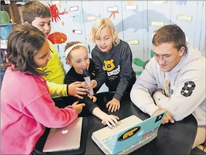  ?? [JOSHUA A. BICKEL/DISPATCH] ?? Barrington Elementary School fourth-graders, from left, Sofia Jaroniec, 9, Scotty Sullivan, 9, Claire Wessells, 9, and Leah Hoffman, 10, practice a pep-rally script for Dante Landolfi as they prepare for the “Beat Michigan! Beat Cancer!” 5K and...