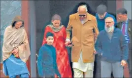  ?? AFP ?? REUNION: Farooq Abdullah (centre) with his son Omar Abdullah and other family members at latter’s house in Srinagar on Saturday. The National Conference patron went to meet his son, who is still in detention, a day after he was released from house arrest after seven months. >>P7