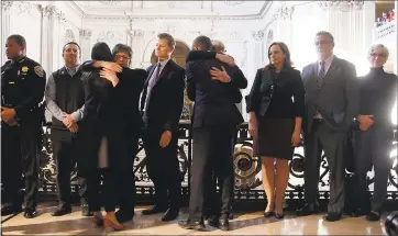  ?? KARL MONDON — STAFF PHOTOGRAPH­ER ?? Hugs are exchanged among politician­s and family gathered in the San Francisco City Hall rotunda for a news conference following the death of San Francisco Mayor Edwin Lee on Tuesday.