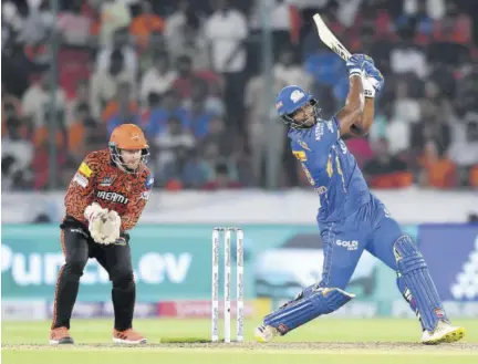  ?? (Photo: AFP) ?? Mumbai Indians’ Romario Shepherd (right) plays a shot as Sunrisers Hyderabad’s wicketkeep­er Heinrich Klaasen looks on during their Indian Premier League Twenty20 cricket match at the Rajiv Gandhi Internatio­nal Stadium in Hyderabad on Wednesday.