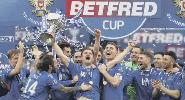  ??  ?? Liam Craig, with the trophy in hand, and the rest of the St Johnstone squad celebrate yesterday’s 1-0 victory against Livingston