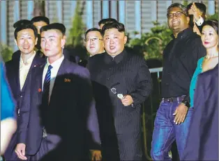  ?? AP PHOTO ?? North Korean leader Kim Jong Un, centre, is escorted by his security delegation as he visits Marina Bay in Singapore, Monday.