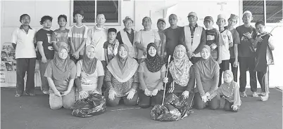  ??  ?? AMAT Jutrah (berdiri, tujuh dari kiri) bersama AJK Combi merakamkan gambar sebelum memulakan aktiviti membersihk­an Perumahan Taman Sepanggar.