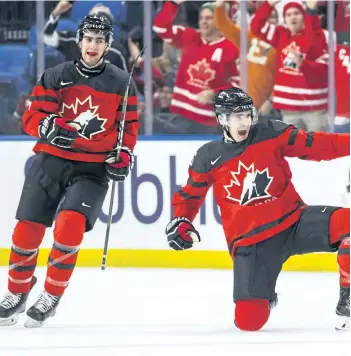  ?? MARK BLINCH/THE CANADIAN PRESS ?? Canada’s Taylor Raddysh, centre, celebrates his goal with teammate Conor Timmins during the second period of IIHF World Junior Ice Hockey Championsh­ip preliminar­y round hockey action against Finland, in Buffalo, N.Y., on Tuesday.