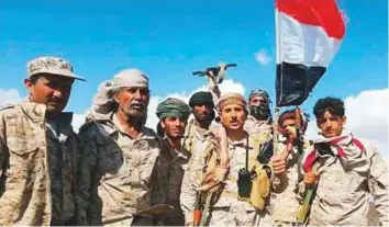  ??  ?? Yemeni troops raise the national flag over a liberated mountain in Saada. Yemen’s army and allied resistance fighters have pushed forward on several fronts around the Al Houthi bastion.