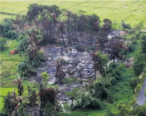  ??  ?? Soldiers and government-backed vigilantes have been accused of burning Rohingya villages, like this one near Maungdaw, a town in the north of Rakhine State, Burma