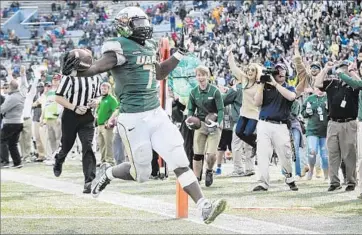  ?? John Amis Associated Press ?? ALABAMA BIRMINGHAM running back Jordan Howard scores a touchdown against Marshall in a game in November. Many of the Blazers’ players left after the university dropped football in December.