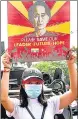  ?? REUTERS ?? A demonstrat­or holds up a placard with the image of Aung San Suu Kyi in Yangon, Myanmar, on Monday.