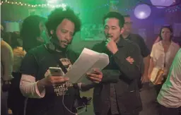  ?? PETER PRATO/ANNAPURNA PICTURES ?? Director Boots Riley (left) and actor Steven Yeun work on the set of “Sorry to Bother You.”