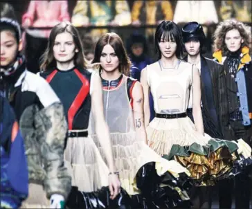  ?? AFP ?? Louis Vuitton ended Paris Fashion Week with a ‘clash of epochs’ extravagan­za at the Louvre museum featuring a 200-person choir in period costumes that went from the 15th century to the 1950s.