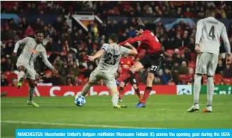  ??  ?? MANCHESTER: Manchester United’s Belgian midfielder Marouane Fellaini (C) scores the opening goal during the UEFA Champions League group H football match between Manchester United and Young Boys at Old Trafford in Manchester, north-west England on Tuesday. — AFP