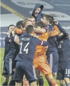  ??  ?? 0 Scotland celebrate in Belgrade after qualifying for Euro 2020