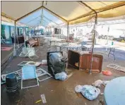  ?? Eduardo Contreras San Diego Union-Tribune ?? SUDDEN precipitat­ion overwhelme­d low-lying areas throughout San Diego County, including the Alpha Project tent shelter in the Barrio Logan area.