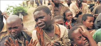  ?? Pictures: AP and PA. ?? Rwandan refugee children plead with Zairian soldiers to let them cross a bridge to rejoin their mothers who had crossed the bridge moments before the soldiers closed the border, in Bukavu, Zaire on August 20 1994. For years, majority Hutus and minority...