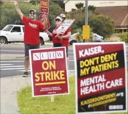  ?? The Maui News / MATTHEW THAYER photo ?? Kaiser mental health clinicians wave signs near the Kaiser Maui Lani Medical Office in May during a three-day statewide strike to raise concerns over understaff­ed clinics and ongoing contract negotiatio­ns. When Kaiser and the National Union of Healthcare Workers failed to come to an agreement, clinicians launched an open-ended strike in August. On Thursday, the two sides announced they had come to a tentative agreement. Union members must now vote on whether to accept the agreement and end the strike or to reject it and resume picketing.