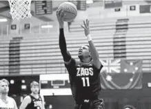  ?? STEVE DYKES AP ?? Gonzaga guard Joel Ayayi drives to the basket during the first half against Portland. He recorded the school’s first triple-double.