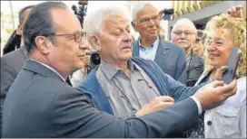  ?? AFP ?? Outgoing French president Francois Hollande (left) poses for a selfie with supporters as he leaves after casting his vote at a polling station in Tulle.