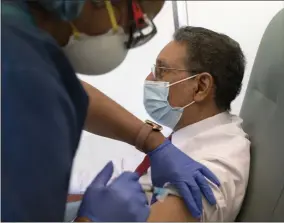  ?? JACQUELYN MARTIN— ASSOCIATED PRESS ?? In this Wednesday, Feb. 10, 2021, photo Wallace Charles Smith, 72, who is a pastor at Shiloh Baptist Church, receives his first COVID-19 vaccinatio­n by nurse Michelle Martin, at United Medical Center in southeast Washington.