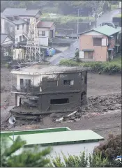  ?? THE ASSOCIATED PRESS ?? Buildings are seen damaged by a massive mudslide at the Izusan district in Atami, west of Tokyo, on Saturday following heavy rains.