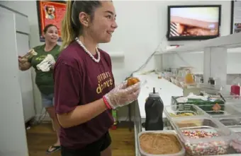  ?? Steve Mellon/ Post- Gazette photos ?? Jordan Gracie’s family owns Jordan's Donuts in Coraopolis. Her mother, Cloressa, left, helped her fine- tune the family’s icing recipe, which serves as the doughnuts’ canvas.