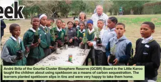  ??  ?? André Britz of the Gourtiz Cluster Biosphere Reserve (GCBR) Board in the Little Karoo taught the children about using spekboom as a means of carbon sequestrat­ion. The learners planted spekboom slips in tins and were very happy to take them home.