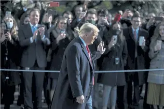  ?? Oliver Contreras, © The New York Times Co. ?? President Donald Trump greets a crowd at the White House on Tuesday before boarding Marine One for a trip to Alamo, Texas, his first public appearance in nearly a week after his supporters violently attacked the U.S. Capitol.