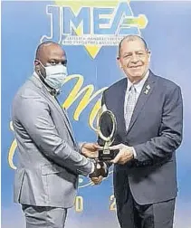  ??  ?? Sheldon Sharpe (left), packaging manager at Red Stripe, collects the Robert Lightbourn­e award for productivi­ty and competitiv­eness from Minister of Industry, Investment and Commerce (MIIC) Audley Shaw during a virtual staging of the JMEA’S M&E awards ceremony.