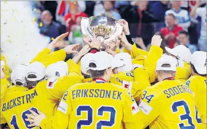  ?? AP PHOTO ?? Sweden players celebrate with the trophy following the Ice Hockey World Championsh­ips final match between Canada and Sweden in the LANXESS arena in Cologne, Germany, Sunday.