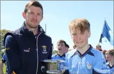  ??  ?? Cathal Murphy receives the trophy from Anthony Masterson.