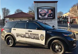  ?? Submitted photo ?? Hot Springs Police Sgt. Joey Williams parked his unit at Hill Wheatley Plaza Thursday morning under the plaza’s marquee as it displays a photo honoring Cpl. Brent Scrimshire, who was killed in the line of duty on March 10, 2020, on the anniversar­y of his death. Photo courtesy of Williams.