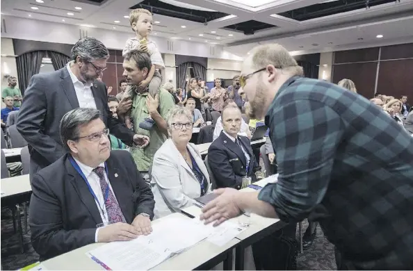  ?? PAUL CHIASSON/THE CANADIAN PRESS FILES ?? A demonstrat­or confronts Montreal Mayor Denis Coderre during an August 2016 hearing into the Energy East project in Montreal. Saint John Mayor Don Darling blamed opponents of the project in Quebec and the regulatory process for Energy East’s demise.