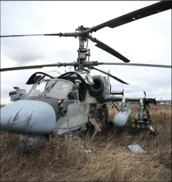  ?? ASSOCIATED PRESS ?? A Russian Ka-52 helicopter gunship is seen in the field after a forced landing outside Kyiv, Ukraine, Feb. 24. Kyiv was a Russian defeat for the ages. It started poorly for the invaders and went downhill from there.