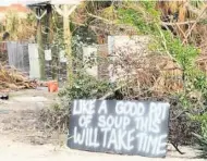  ?? COURTESY OF KIMBERLY SANDERS ?? Sanibel Island was hit hard by Hurricane Ian. This sign says that 'Like a good pot of soup this will take time' to repair.