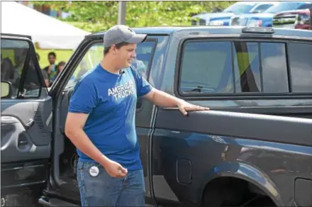  ?? PETE BANNAN – DIGITAL FIRST MEDIA ?? Make-A-Wish recipient, Levi King, 18, checks out his dream truck makeover from Turn5. Some $20,000 worth of modificati­ons were done to King’s 1996 Ford F150.