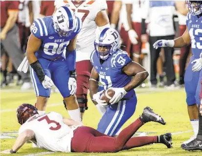  ?? NELL REDMOND/AP ?? Duke defensive end Victor Dimukeje (51) recovers a fumble by Virginia Tech quarterbac­k Braxton Burmeister during a game Oct. 3, 2020, in Durham, N.C.