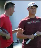  ?? MICHAEL REAVES/GETTY IMAGES ?? Head coach Kyle Shanahan of the San Francisco 49ers (left) talks with general manager John Lynch during practice for Super Bowl LIV.