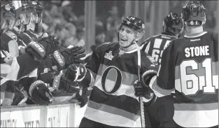  ?? The Canadian Press ?? Ottawa Senator Alexandre Burrows celebrates after scoring a goal against the Colorado Avalanche during an NHL game in Ottawa on Thursday. Burrows scored twice in his debut with the Senators and led his new club to a 2-1 win over Colorado. He was traded...