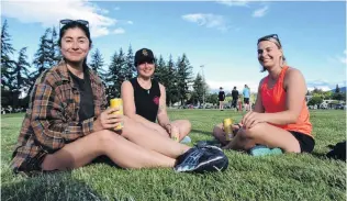  ?? PHOTO: MARK PRICE ?? Thirsty work . . . Bella Couwenberg (26, left), Emma Shaw (26, centre) and Fi Brown (30), all of Wanaka, have a cheeky drink while waiting to bat during the sixa side cricket at Wanaka Showground­s earlier this week.