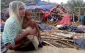  ?? — AFP ?? A Rohingya refugee sits near a house destroyed by Cyclone Mora in a camp in the Cox’s Bazar district on Wednesday.