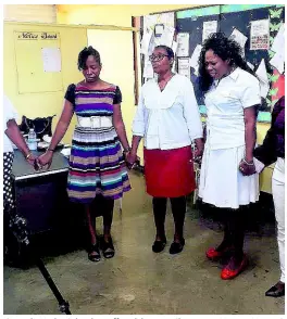  ??  ?? Central High School staff celebrates Chairman Henry Morant’s resignatio­n with a word of prayer.