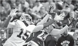  ?? KENNETH K. LAM/BALTIMORE SUN ?? Shareece Wright, right, breaks up a pass intended for Oakland’s Michael Crabtree in the third quarter Sunday. Two of Crabtree’s three touchdown catches were against Wright.