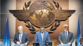  ?? PAUL CHIASSON/THE CANADIAN PRESS ?? Transport Minister Marc Garneau, left, ICAO president Olumuyiwa Benard Aliu, and Quebec Premier Philippe Couillard arrive for the UN aviation agency assembly Tuesday in Montreal.